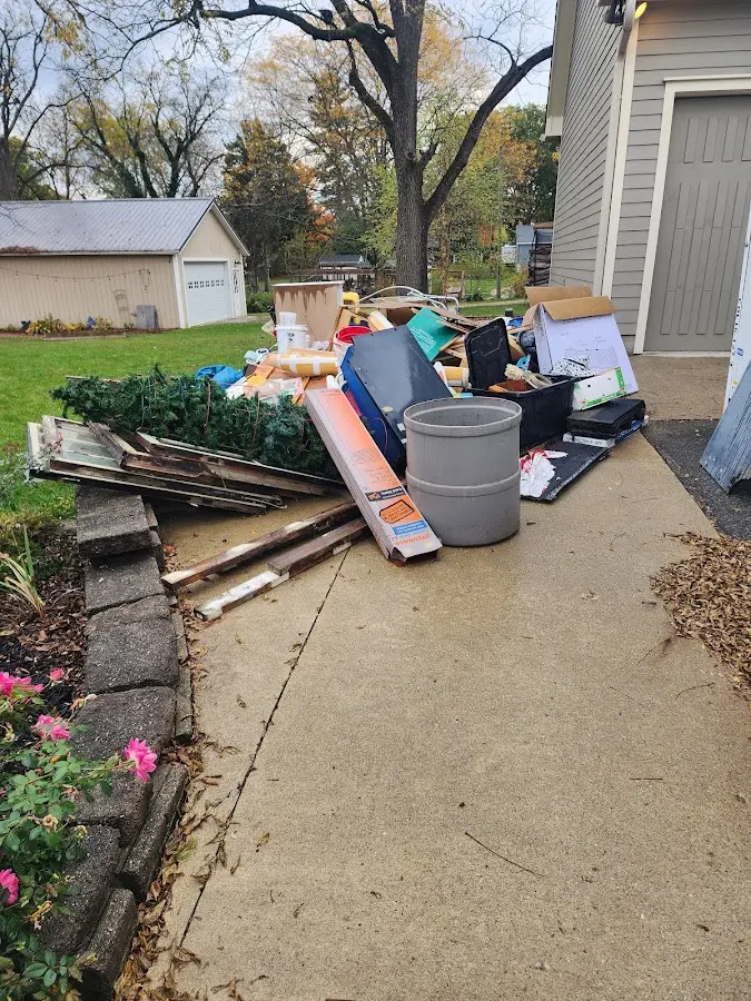 Dumpster being loaded with debris for Estate Cleanout Dumpster Rental in Bradford